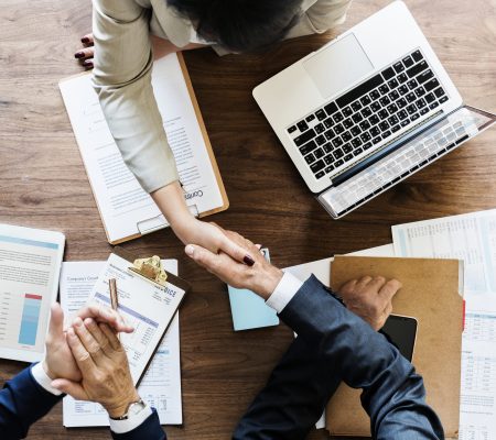 Business people shaking hands together